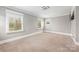 Spacious bedroom with neutral carpet, light-gray walls, and window views providing ample natural light at 232 Cromer St, Charlotte, NC 28208