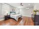 Spacious bedroom with a ceiling fan, hardwood floors, and bright windows at 232 Cromer St, Charlotte, NC 28208