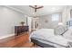 Bedroom featuring hardwood floors, a ceiling fan, and ensuite bath access at 232 Cromer St, Charlotte, NC 28208