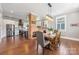 Open dining area with a rustic wood table, stylish chairs, and a brick accent wall at 232 Cromer St, Charlotte, NC 28208