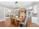 Spacious dining area with open floor plan, rustic table, and access to the living room and kitchen at 232 Cromer St, Charlotte, NC 28208