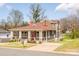 Beautiful two-story home with a welcoming porch, mature trees, and a well-maintained lawn at 232 Cromer St, Charlotte, NC 28208
