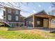 Rear view of a two-story home and garage with a covered drive and grassy yard at 232 Cromer St, Charlotte, NC 28208
