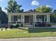 Charming single Gathering home with a welcoming front porch, white pillars, stone accents, and well-manicured lawn at 232 Cromer St, Charlotte, NC 28208