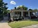 Charming single Gathering home with a welcoming front porch, white pillars, stone accents, and well-manicured lawn at 232 Cromer St, Charlotte, NC 28208