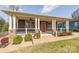 Charming home featuring a welcoming front porch with stone accents and a bright red door at 232 Cromer St, Charlotte, NC 28208