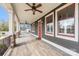 Expansive front porch featuring ceiling fans, red-trimmed windows, and wood-look flooring at 232 Cromer St, Charlotte, NC 28208