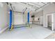 Spacious garage equipped with a car lift, work bench, and ample storage space at 232 Cromer St, Charlotte, NC 28208