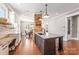 Bright kitchen features granite countertops, custom cabinets, brick accent wall and hardwood floors at 232 Cromer St, Charlotte, NC 28208