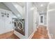 Modern laundry room with stainless steel washer and dryer on a raised platform at 232 Cromer St, Charlotte, NC 28208