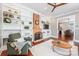 Comfortable living area featuring a brick fireplace, built-in shelving, and a cozy green chair at 232 Cromer St, Charlotte, NC 28208