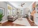 Cozy living room with hardwood floors, a brick fireplace, and plenty of natural light at 232 Cromer St, Charlotte, NC 28208