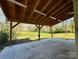 Covered patio featuring wood beams and an outdoor space with an expansive yard view at 232 Cromer St, Charlotte, NC 28208