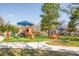 Colorful playground equipment sits in a well-maintained green area of the neighborhood park at 232 Cromer St, Charlotte, NC 28208