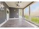Screened porch with tile floors, fan, and outdoor view at 232 Cromer St, Charlotte, NC 28208