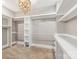 Large walk-in closet with custom shelving and a chandelier at 232 Cromer St, Charlotte, NC 28208