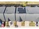 Top-down aerial view of townhome roofs with solar panels and neat, green lawns at 2446 Alyssa Ln, Charlotte, NC 28208