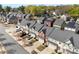 Aerial view of colorful townhomes featuring well-kept lawns and a tree-lined neighborhood at 2446 Alyssa Ln, Charlotte, NC 28208