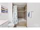 Bathroom with tiled shower-tub combo and patterned shower curtain at 2446 Alyssa Ln, Charlotte, NC 28208