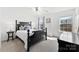 Sun-filled bedroom featuring a dark wood bed frame and accents, complemented by neutral carpet and walls at 2446 Alyssa Ln, Charlotte, NC 28208