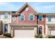 Charming townhome featuring a red facade, brick accents, and a two-car garage at 2446 Alyssa Ln, Charlotte, NC 28208
