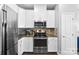 Contemporary kitchen boasts stainless steel appliances and stylish tile backsplash at 2446 Alyssa Ln, Charlotte, NC 28208