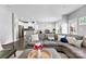 Bright, open-concept living area with a gray sectional sofa and wood flooring at 2446 Alyssa Ln, Charlotte, NC 28208