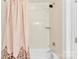 Close up of shower-tub combo with decorative shower curtain at 2446 Alyssa Ln, Charlotte, NC 28208