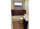 Cozy bathroom features a classic vanity, bathtub with a shower, and wood paneling at 2609 E Greenbriar Rd, Statesville, NC 28625