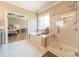Bright bathroom featuring a tub and glass shower and an adjoined bedroom visible from doorway at 2616 Creek Manor Dr, Waxhaw, NC 28173