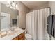 Well-lit bathroom features a shower with curtain, white toilet, and a vanity with a mirror at 2616 Creek Manor Dr, Waxhaw, NC 28173