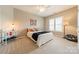 Cozy bedroom with a decorative theme, a comfortable bed and a plush carpet at 2616 Creek Manor Dr, Waxhaw, NC 28173