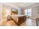 Well-lit bedroom with a large bed and wood flooring at 2616 Creek Manor Dr, Waxhaw, NC 28173