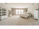 Spacious bedroom with a white bed, multiple storage shelves, and bright window at 2616 Creek Manor Dr, Waxhaw, NC 28173