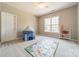 Bright bedroom with plush carpet, featuring a play area with tent, toy shelf, and rug at 2616 Creek Manor Dr, Waxhaw, NC 28173