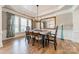Elegant dining room featuring a coffered ceiling, hardwood floors, and large windows for natural light at 2616 Creek Manor Dr, Waxhaw, NC 28173