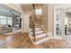 Open foyer with wooden staircase and views into the living room at 2616 Creek Manor Dr, Waxhaw, NC 28173