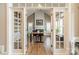 Stylish home office with hardwood floors, a fireplace, built-in shelves, and ample natural light at 2616 Creek Manor Dr, Waxhaw, NC 28173