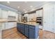 Spacious kitchen featuring a center island, custom cabinets, granite countertops, and stainless steel appliances at 2616 Creek Manor Dr, Waxhaw, NC 28173