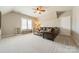 Spacious living room features a comfortable leather sofa, ceiling fan, and a window with bench seating at 2616 Creek Manor Dr, Waxhaw, NC 28173