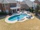 An in-ground kidney-shaped pool is surrounded by stone pavers and lounge furniture at 2616 Creek Manor Dr, Waxhaw, NC 28173