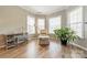 Bright sitting area with three windows, hardwood flooring, workstation and comfortable seating at 2616 Creek Manor Dr, Waxhaw, NC 28173