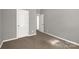 This bedroom offers neutral walls and flooring and two doors leading to other rooms in the home at 282 W Shiloh Unity Rd, Lancaster, SC 29720