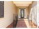 Inviting front porch with brick steps, decorative railing, and a stylish front door with glass panels at 282 W Shiloh Unity Rd, Lancaster, SC 29720