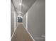 This bright hallway offers neutral gray walls, plush tan flooring, and multiple doors at 282 W Shiloh Unity Rd, Lancaster, SC 29720