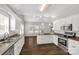 Spacious kitchen features a view into the dining room, stainless steel appliances, and wood-look floors at 282 W Shiloh Unity Rd, Lancaster, SC 29720