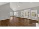 Bright living room with hardwood floors, ceiling fan, and a door leading to outdoor living space at 282 W Shiloh Unity Rd, Lancaster, SC 29720