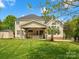Expansive backyard with a covered patio, lush green lawn, and a shed, creating a serene and inviting outdoor space at 3100 Stanway Ct, Waxhaw, NC 28173