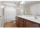 Bright bathroom featuring a double vanity, white shower curtain, and tile flooring at 3100 Stanway Ct, Waxhaw, NC 28173