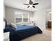 Well-lit bedroom features a ceiling fan, a window with blinds, and an adjacent bathroom at 3100 Stanway Ct, Waxhaw, NC 28173